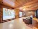 Inviting living room with wood paneled walls, hardwood floors, and an open layout at 2900 Cr 415, Lake Panasoffkee, FL 33538