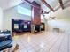 Spacious living room features a stone fireplace, wood beams, and access to a cozy den at 2900 Cr 415, Lake Panasoffkee, FL 33538