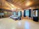 Cozy living room with wood paneled walls, built-in bookshelves, and natural light at 2900 Cr 415, Lake Panasoffkee, FL 33538