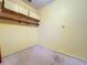 Small room with empty yellow walls, an electrical outlet, a ceiling vent, and a small amount of debris at 2900 Cr 415, Lake Panasoffkee, FL 33538