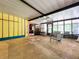 Enclosed porch with bright yellow walls, ceiling fan, and sitting area at 2900 Cr 415, Lake Panasoffkee, FL 33538