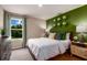 Welcoming bedroom with a bright green accent wall, a side dresser, and ample natural light at 1748 Frogmore Ave, Haines City, FL 33844