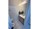 Bright bathroom featuring a vanity, mirror, and decor, enhancing the room's aesthetic appeal at 2528 Deerbrook Dr, Lakeland, FL 33811