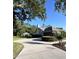 Exterior view of home featuring a side driveway, detached garage and mature landscaping at 2528 Deerbrook Dr, Lakeland, FL 33811