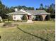 Charming single-story home with a well-maintained lawn and a welcoming red front door at 2528 Deerbrook Dr, Lakeland, FL 33811