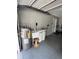 View of the garage with water tanks and a utility sink, providing functionality at 2528 Deerbrook Dr, Lakeland, FL 33811