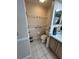 Cozy half bathroom with tile floor, a toilet with safety bars, and vanity sink at 2528 Deerbrook Dr, Lakeland, FL 33811