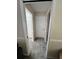 Neutral hallway with gray carpet leading to a walk-in closet, and a closed door for privacy at 2528 Deerbrook Dr, Lakeland, FL 33811