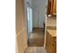 Hallway in the kitchen with a sliding glass door and tile flooring leading to another room at 2528 Deerbrook Dr, Lakeland, FL 33811