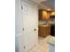 Kitchen pantry with a door showcasing oak cabinetry with granite countertops and backsplash at 2528 Deerbrook Dr, Lakeland, FL 33811