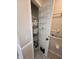 Handy linen closet with shelves and door organizer, ideal for storage at 2528 Deerbrook Dr, Lakeland, FL 33811
