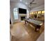 Bright living room with a pool table, fireplace, and built-in shelving for ample storage at 2528 Deerbrook Dr, Lakeland, FL 33811