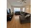 Bright living room with a large sectional sofa and a ceiling fan at 2528 Deerbrook Dr, Lakeland, FL 33811