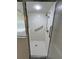Clean white tiled walk-in shower with safety bars and modern fixtures at 2528 Deerbrook Dr, Lakeland, FL 33811