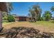 Backyard with metal roof, mature trees, and shaded lawn at 3646 Palm Rd, Lakeland, FL 33810