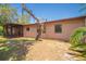 View of the home's backyard, with a screened porch and a large tree in the yard at 3646 Palm Rd, Lakeland, FL 33810