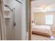 Bathroom shower and bedroom featuring natural light, ceiling fan, and bed at 3646 Palm Rd, Lakeland, FL 33810