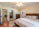 Bedroom featuring ceiling fan, wood frame bed, view to bathroom, and natural light at 3646 Palm Rd, Lakeland, FL 33810