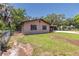 Cozy home with manicured lawn, mature trees, and driveway at 3646 Palm Rd, Lakeland, FL 33810