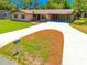 Inviting home featuring a long driveway and well-maintained landscaping at 3646 Palm Rd, Lakeland, FL 33810