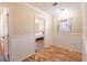 Hallway featuring wood-style floors and a half-wall of classic wood paneling at 3646 Palm Rd, Lakeland, FL 33810