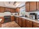 A sunlit kitchen features tile flooring, countertops, wood cabinetry, and modern appliances at 3646 Palm Rd, Lakeland, FL 33810