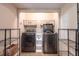 A closet laundry area is fitted with a modern washer and dryer and shelving units at 3646 Palm Rd, Lakeland, FL 33810