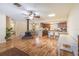 Open-concept living area with hardwood floors and a cozy fireplace at 3646 Palm Rd, Lakeland, FL 33810