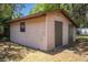 Exterior view of a shed with a window and double doors on a sunny day at 3646 Palm Rd, Lakeland, FL 33810