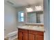 Bright bathroom features a double sink vanity with wood cabinets and an extra large mirror at 4601 Glencrest Loop, St Cloud, FL 34772