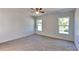 Comfortable bedroom with neutral carpet, bright windows, and ample natural light at 4601 Glencrest Loop, St Cloud, FL 34772