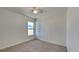 Bedroom featuring neutral carpet, a ceiling fan, and a window offering outside views at 4601 Glencrest Loop, St Cloud, FL 34772