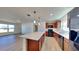 Modern kitchen boasts white countertops, stainless steel appliances, and a large island at 4601 Glencrest Loop, St Cloud, FL 34772