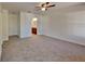 Large main bedroom with carpet, ceiling fan, and ensuite bathroom access at 4601 Glencrest Loop, St Cloud, FL 34772