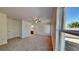 Cozy main bedroom with carpeted floors, a ceiling fan, and a large window for natural light at 4601 Glencrest Loop, St Cloud, FL 34772
