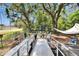 Back yard with wheelchair access and a covered hot tub in a wooded area at 528 S Seminole Ave, Fort Meade, FL 33841