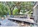 Large back deck with railings leads to the back door; a hot tub is visible at 528 S Seminole Ave, Fort Meade, FL 33841