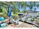 Back yard with patio seating, wheelchair access and covered hot tub and partial view of house at 528 S Seminole Ave, Fort Meade, FL 33841