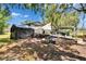 A spacious backyard featuring a makeshift tent cover and a ramp leading up to a covered structure with white sheeting at 528 S Seminole Ave, Fort Meade, FL 33841
