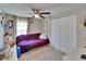 Cozy bedroom with a ceiling fan, closet, and comfortable seating area at 528 S Seminole Ave, Fort Meade, FL 33841