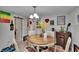 Inviting dining area featuring an open layout, hardwood floors, modern lighting, and space for Gathering gatherings at 528 S Seminole Ave, Fort Meade, FL 33841