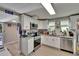 Updated kitchen with stainless steel appliances, granite countertops, white cabinets, and modern fixtures at 528 S Seminole Ave, Fort Meade, FL 33841
