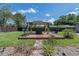 Wooden deck with gazebo, outdoor seating, fire pit, and lush green lawn at 1416 Leighton Ave, Lakeland, FL 33803