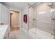 Bathroom featuring a glass-enclosed shower over a tub, with a door to another room at 1416 Leighton Ave, Lakeland, FL 33803