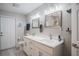 Bright bathroom featuring a double vanity, modern fixtures, and a glass-enclosed shower over tub at 1416 Leighton Ave, Lakeland, FL 33803