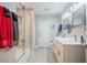Bright bathroom with double sinks, white marble countertops, and glass-enclosed tub and shower at 1416 Leighton Ave, Lakeland, FL 33803