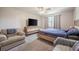 Neutral bedroom with an oversized television, accent chair, and large window at 1416 Leighton Ave, Lakeland, FL 33803