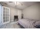 Cozy bedroom features wood flooring, a ceiling fan, and a door with glass panels at 1416 Leighton Ave, Lakeland, FL 33803