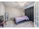 Bedroom with a ceiling fan, wood look floors, and a large French door at 1416 Leighton Ave, Lakeland, FL 33803
