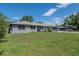 Attractive gray home with a well-manicured front yard and a beautiful front garden at 1416 Leighton Ave, Lakeland, FL 33803